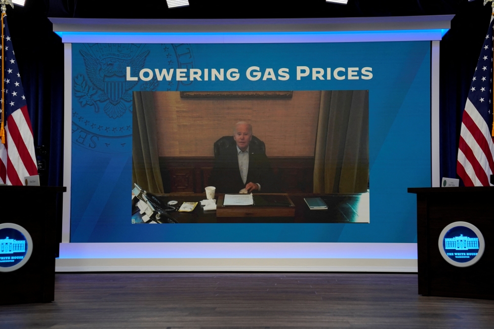 US President Joe Biden, who has coronavirus disease (COVID-19) appears on a screen during a virtual meeting with his economic team at the White House in Washington, US, July 22, 2022. REUTERS/Elizabeth Frantz