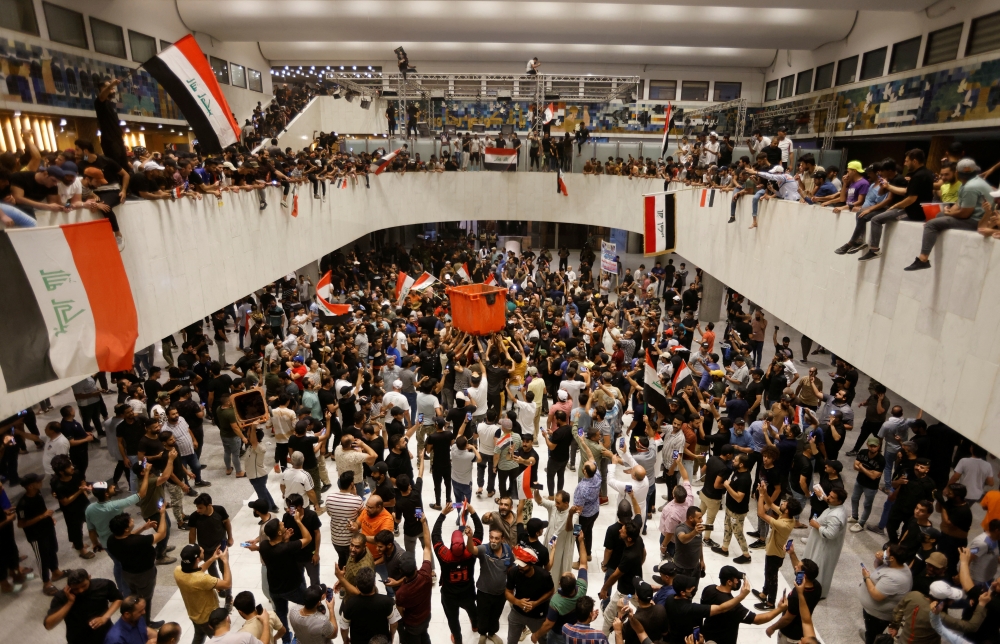 Supporters of Iraqi Shi'ite cleric Moqtada al-Sadr protest against corruption inside the parliament building in Baghdad, Iraq, July 27, 2022. (REUTERS/Ahmed Saad)