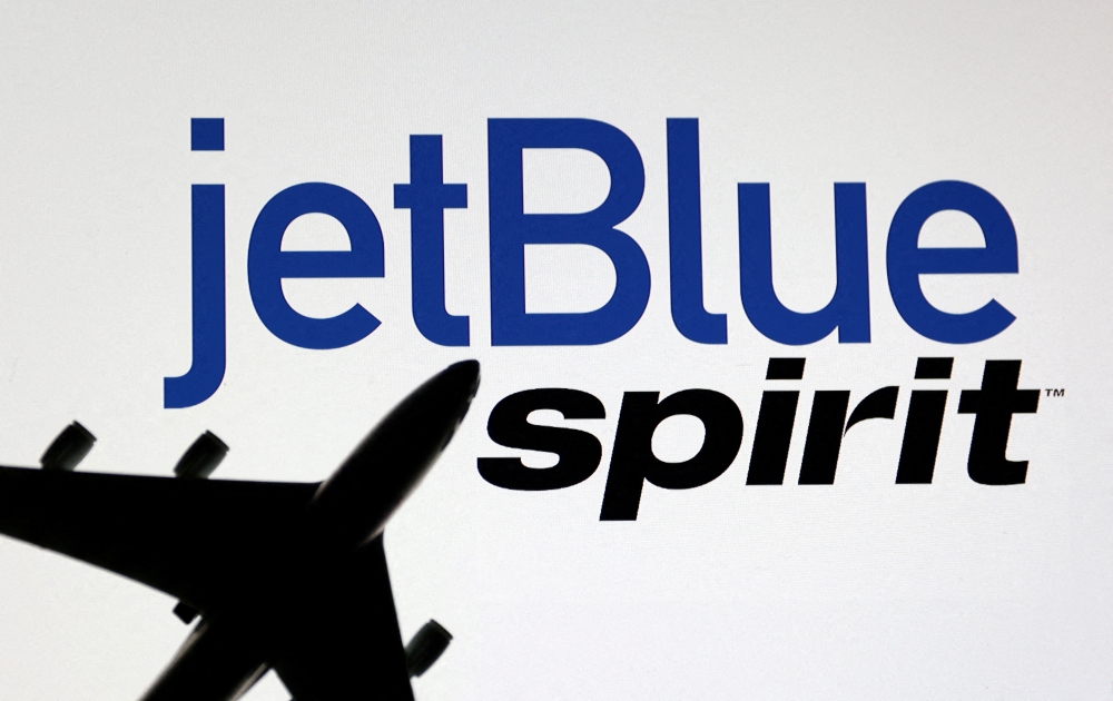 File Photo: Airplane model is placed on displayed Spirit Airlines and JetBlue Airways logos in this illustration taken June 21, 2022. (REUTERS/Dado Ruvic)

