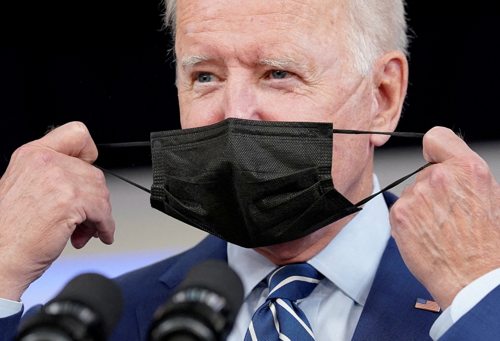 File Photo: US President Joe Biden removes his face mask prior to receiving his COVID-19 booster vaccination in the Eisenhower Executive Office Building's South Court Auditorium at the White House in Washington on September 27, 2021. (REUTERS/Kevin Lamarque)