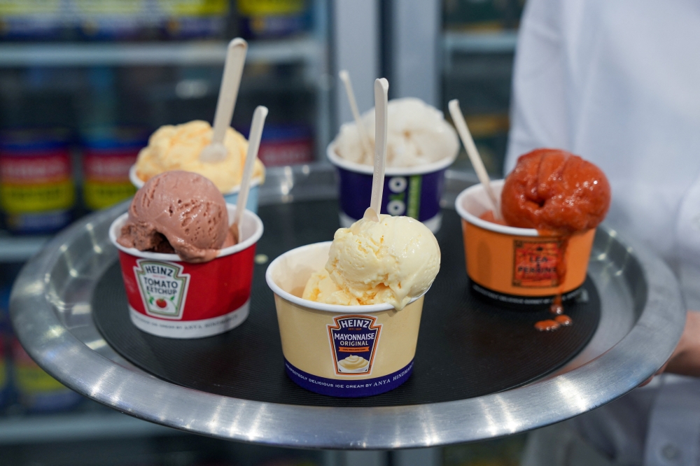 A worker presents favourite cult food brands-flavoured ice cream in a concept store by Anya Hindmarch at The Village, in London, Britain, August 4, 2022. Reuters/Maja Smiejkowska