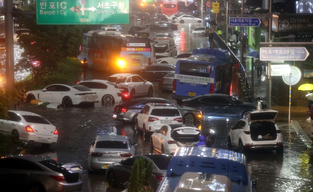 Abandoned vehicles fill the road in flooded area during heavy rain in Seoul, South Korea, August 8, 2022. Yonhap via Reuters