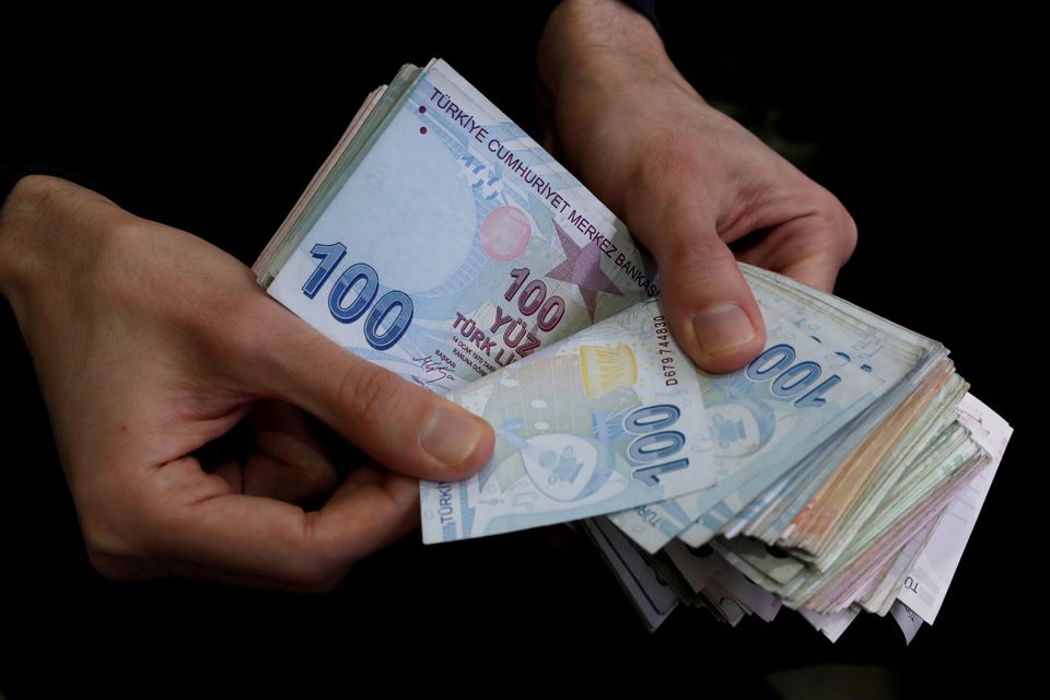 File photo: Hand counting Turkish lira banknotes