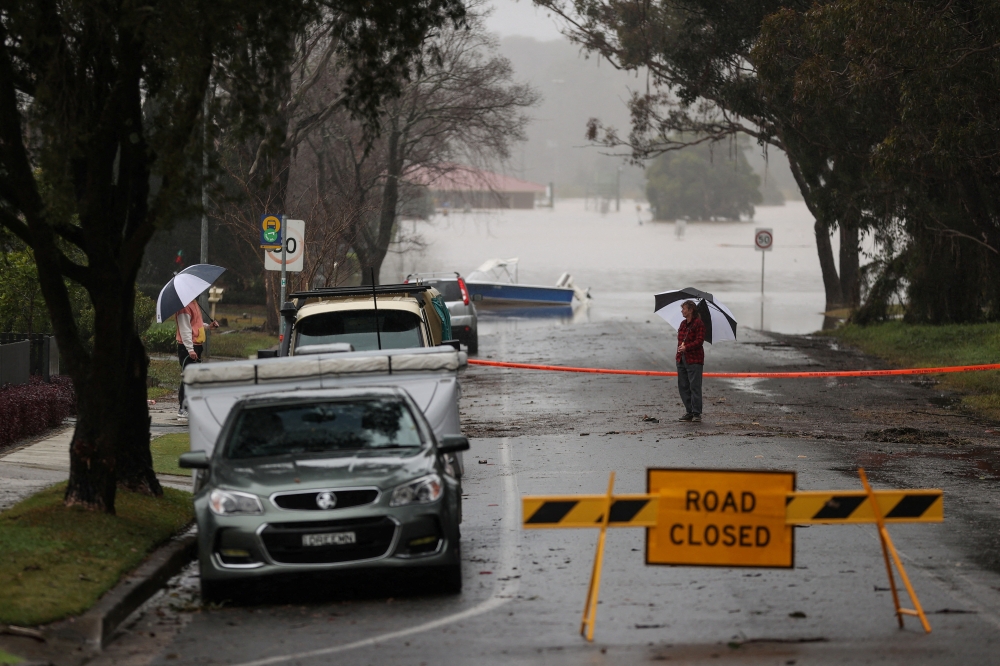 Floodwaters begin to recede after inundating a residential area, following heavy rains and severe flooding in the McGraths Hill suburb of Sydney, Australia, July 6, 2022. REUTERS/Loren Elliott/File Photo