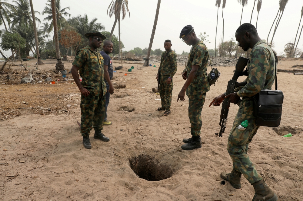 File Photo: Naval officers inspect an illegally-dug oil well at ilashe in Lagos, Nigeria, January 23, 2020. (REUTERS/Temilade Adelaja)