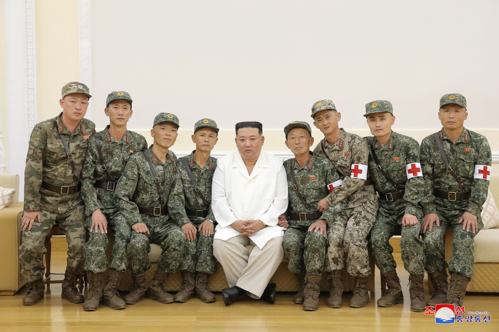 North Korea's leader Kim Jong-un poses for a photo with Korean People's Army medics during a meeting to recognise their contributions in fighting the coronavirus disease (COVID-19) pandemic in Pyongyang, North Korea, August 18, 2022 in this photo released by North Korea's Korean Central News Agency via REUTERS.