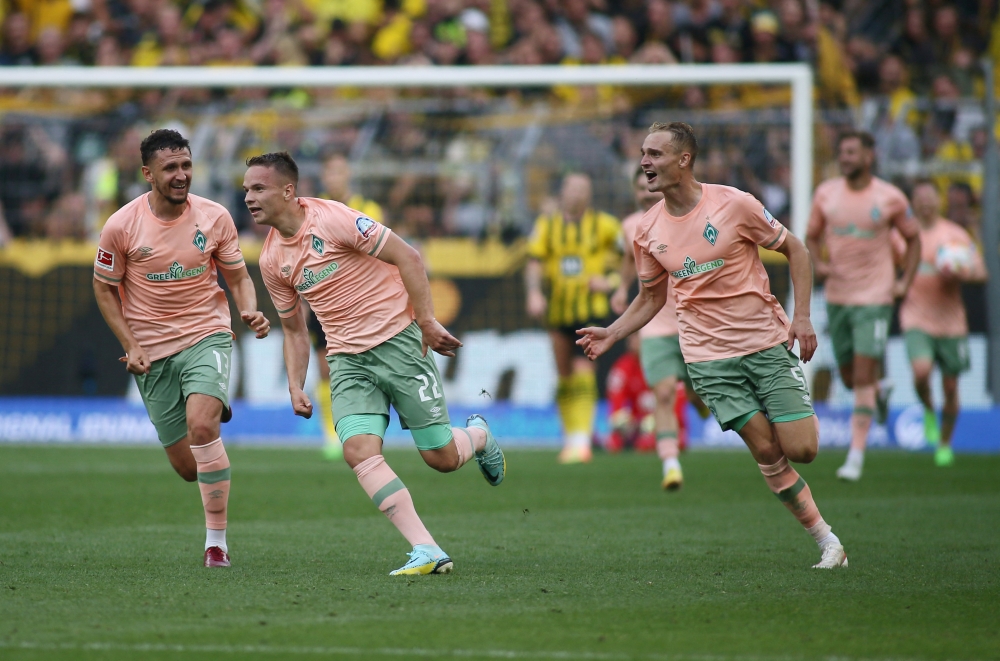Werder Bremen's Niklas Schmidt celebrates scoring their second goal with Milos Veljkovic and Amos Pieper REUTERS/Thilo Schmuelgen