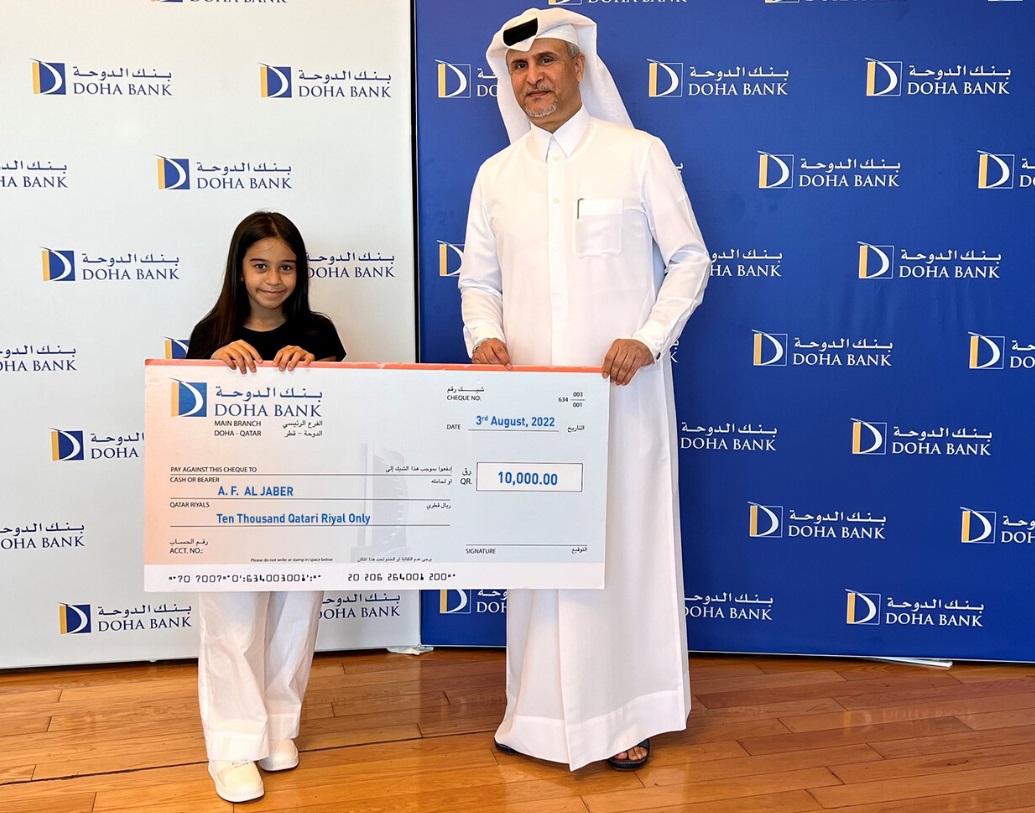 Braik Al Marri, Chief Retail Banking Officer at Doha Bank awards a winner of the 4th Al Dana draw, in Doha, recently. 
