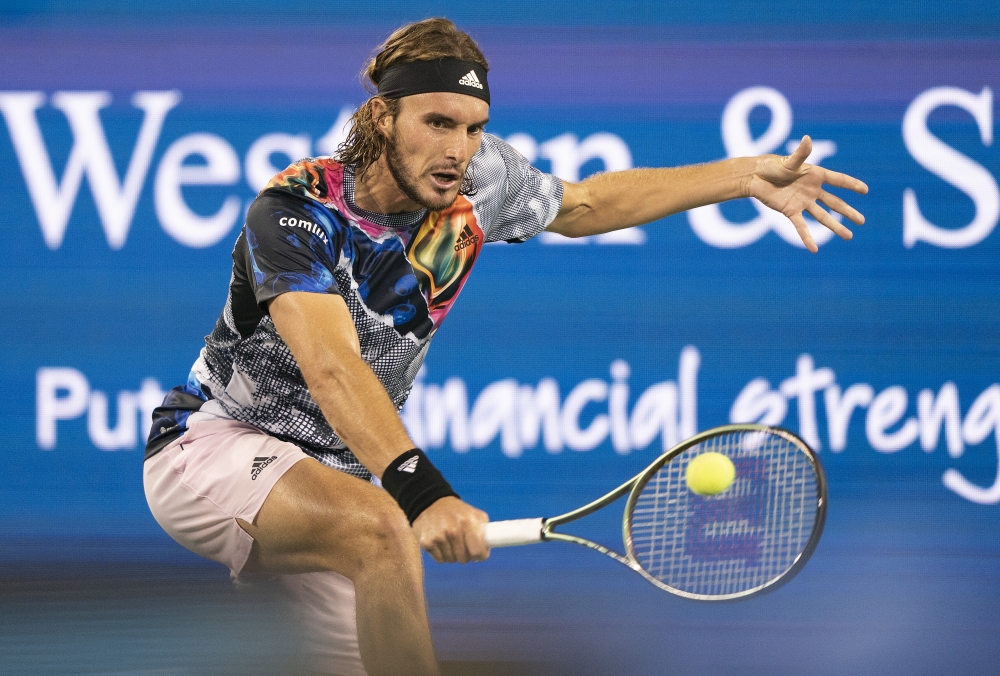 Aug 20, 2022; Cincinnati, OH, USA; Stefanos Tsitsipas (GRE) returns a shot against Daniil Medvedev (RUS) at the Western & Southern Open at the Lindner Family Tennis Center. Mandatory Credit: Susan Mullane-USA TODAY Sports