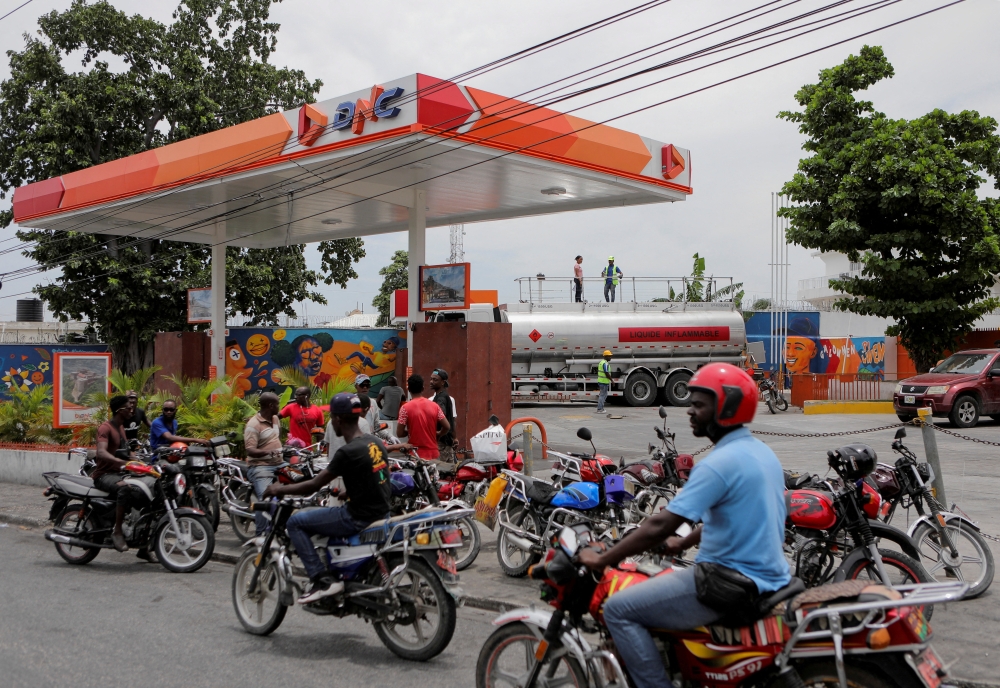 People wait outside a petrol station as Haiti's main fuel terminal renewed deliveries that had been suspended due to an outbreak of gang violence, in Port-au-Prince, on July 14, 2022. File Photo / Reuters
