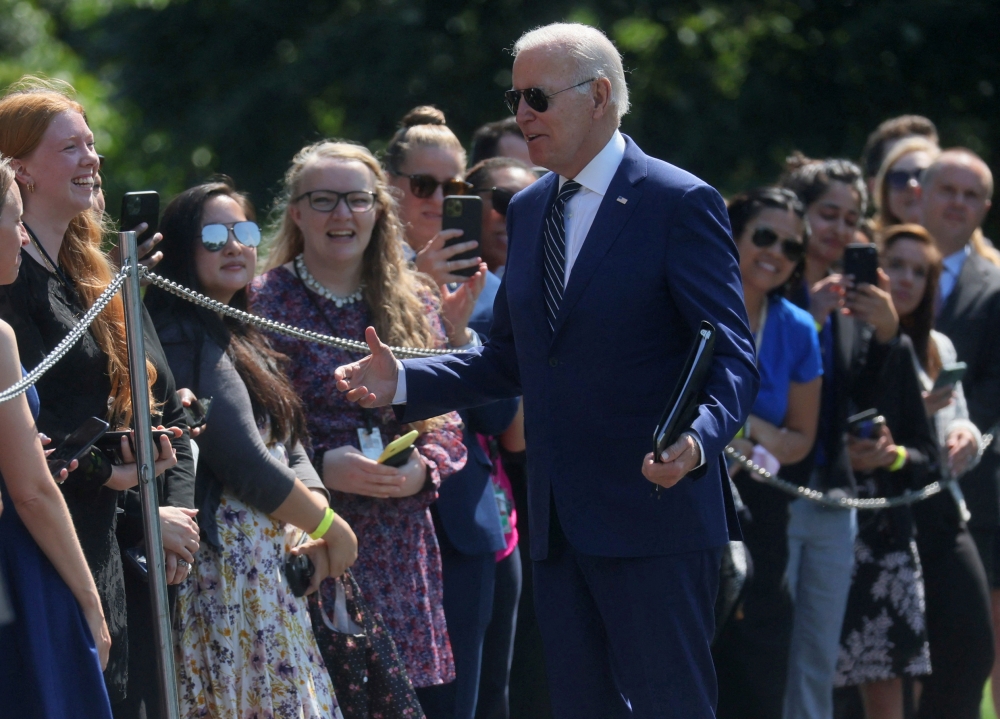 US President Joe Biden greets people on South Lawn after arriving on Marine One from a trip to Delaware at the White House in Washington, on August 24, 2022. REUTERS/Leah Millis