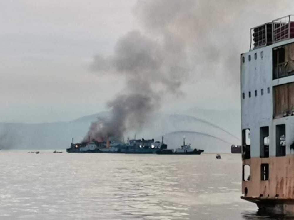 A general view shows smoke erupting from M/V Asia Philippines Starlite shipping vessel at an anchorage area in Batangas, Philippines, August 26, 2022. Philippine Coast Guard/Handout via REUTERS