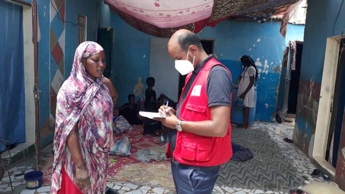 A QRCS representative interacting with a woman affected by flood in Mauritania.
