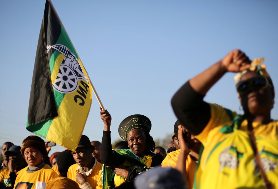 Supporters of the African National Congress hold the party flag during ANC campaign in Atteridgeville a township located to the west of Pretoria, South Africa July 5, 2016. REUTERS/Siphiwe Sibeko

