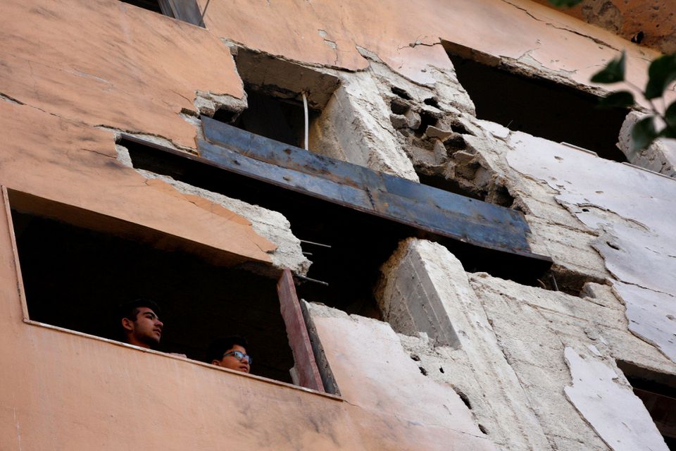 Boys look out the window of a building damaged by an Israeli air strike near Damascus airport, in Damascus, Syria, on November 20, 2019.  File Photo / Reuters