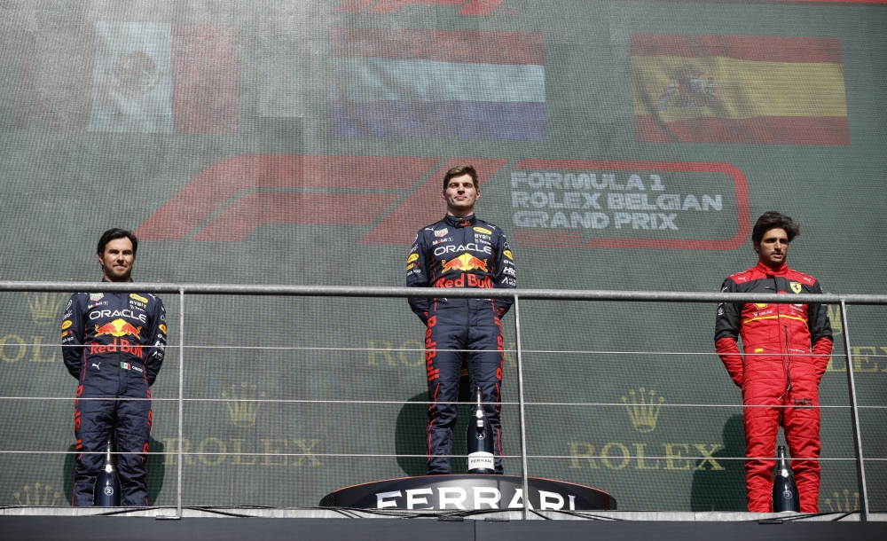 Red Bull's Max Verstappen celebrates on the podium after winning the Belgian Grand Prix with second placed Red Bull's Sergio Perez and third placed Ferrari's Carlos Sainz Jr. at the Spa-Francorchamps, in Spa, Belgium on August 28, 2022.  REUTERS/Johanna Geron