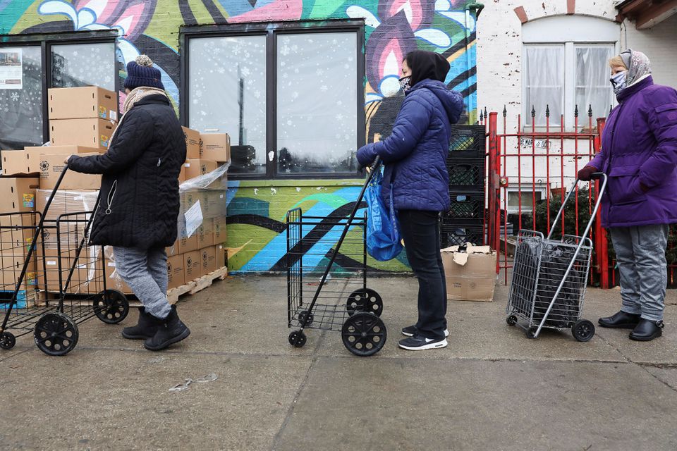 Residents wait to pick up food boxes at the nonprofit New Life Centers' food pantry in Chicago, Illinois, U.S. March 16, 2021. Picture taken March 16, 2021. REUTERS/Daniel Acker

