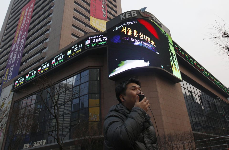 File Photo: A man walks past the main office of Korea Exchange Bank in Seoul, January 27, 2012. (REUTERS/Kim Hong-Ji)