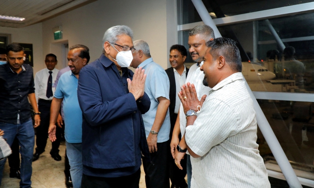 Sri Lanka's ousted President Gotabaya Rajapaksa's party members welcome him and his wife Ioma Rajapaksa at the Bandaranaike International Airport as he returns to the country after he had fled during the July economic unrest and protestors stormed in the president's house in Katunayake, Sri Lanka, on September 2, 2022. PR Media Unit/Handout via Reuters 