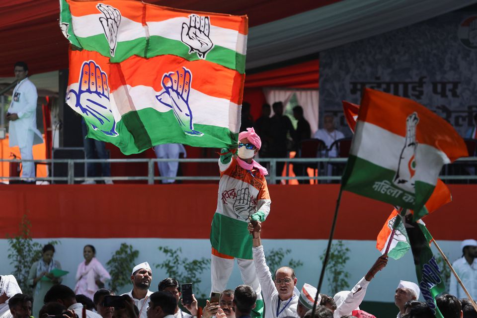 A supporter waves a flag of India's main opposition Congress party at a massive rally organised by the party against inflation, at Ramlila Ground, in New Delhi, on September 4, 2022. REUTERS/Anushree Fadnavis
