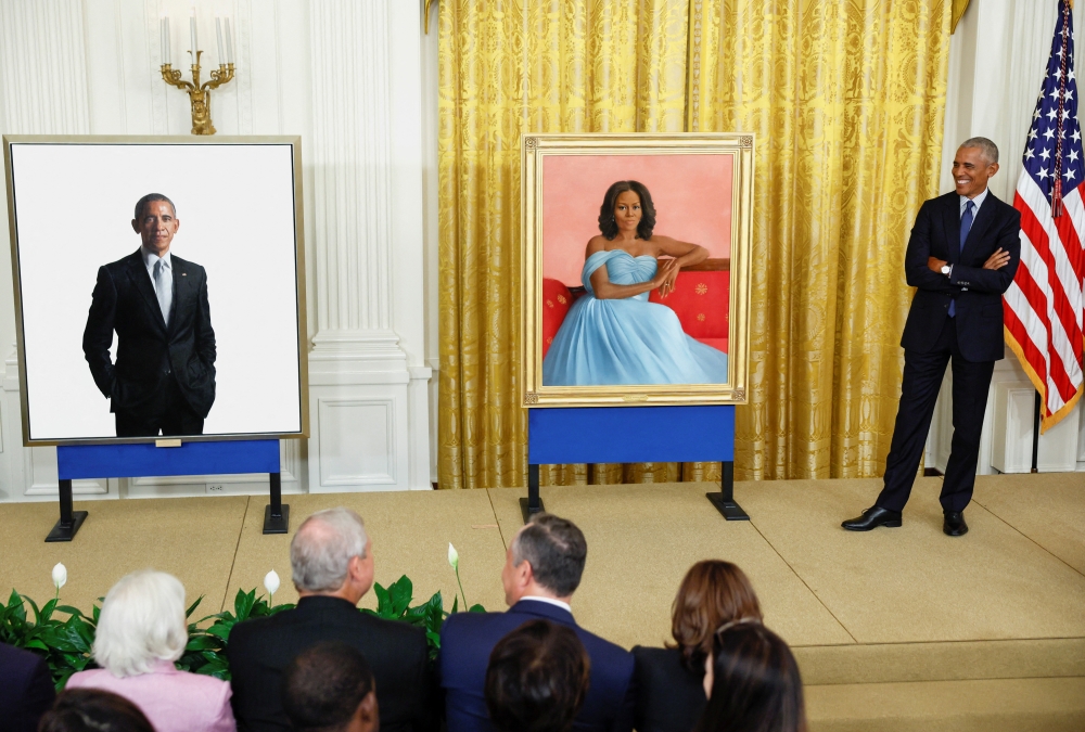 Former US President Barack Obama reacts during the unveiling of his and former first lady Michelle Obama's official White House portraits, painted by Robert McCurdy and Sharon Sprung, respectively, in the East Room of the White House, in Washington, on September, 7, 2022. REUTERS/Evelyn Hockstein