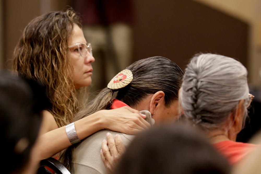 Community members listen to comments by Mark Arcand, brother of stabbing victim Bonnie Burns who was killed at James Smith Cree Nation, at a news conference in Saskatoon, Saskatchewan, Canada, September 7, 2022. Reuters/Valerie Zink