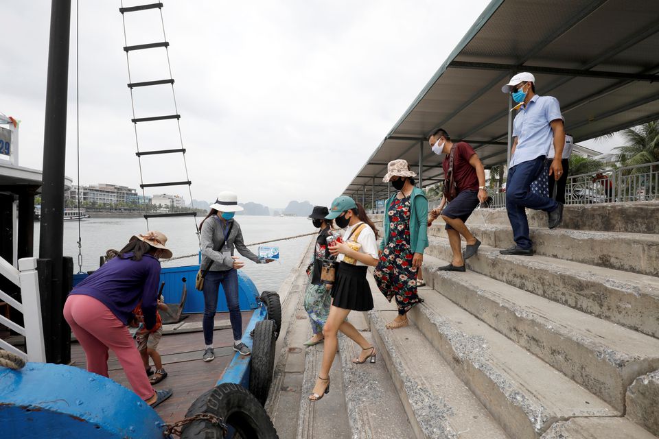 Vietnamese tourists visit Ha Long bay after the Vietnamese government eased the lockdown following the coronavirus disease (COVID-19) outbreak, in Quang Ninh province, Vietnam, May 19, 2020. REUTERS/Kham

