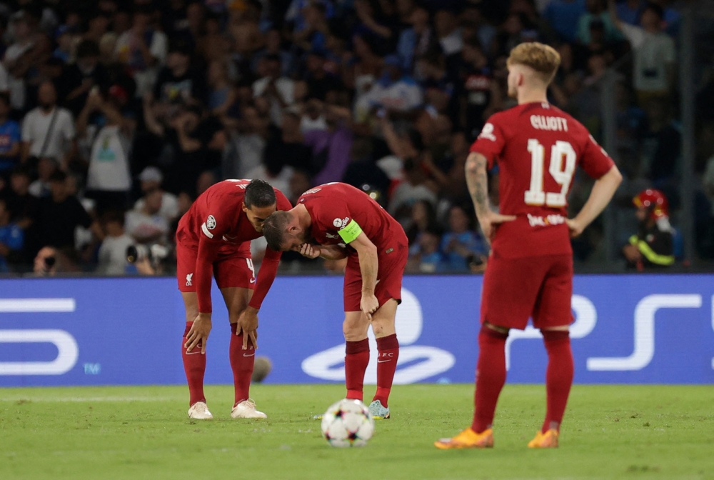 Liverpool's James Milner and Virgil van Dijk react after Napoli's Piotr Zielinski scored their fourth goal REUTERS/Ciro De Luca