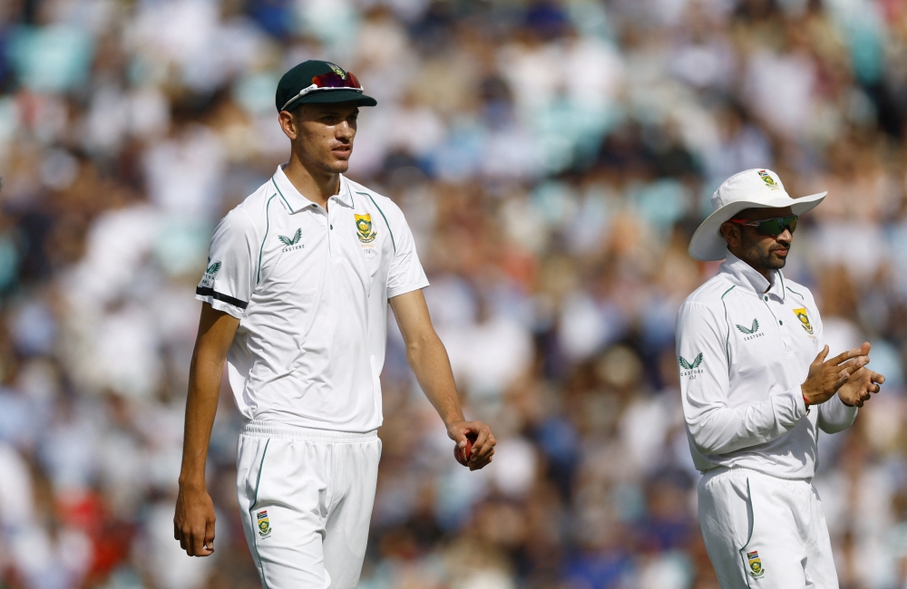 South Africa's Marco Jansen walks off the field while carrying the ball after a five-wicket haul in England's first innings. Reuters/Andrew Boyers