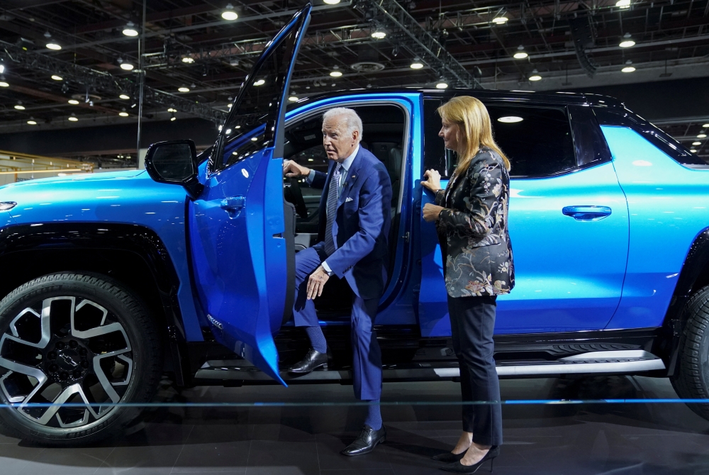 US President Joe Biden steps out of an electric Chevrolet Silverado EV pickup truck during a visit to the Detroit Auto Show to highlight electric vehicle manufacturing in America, in Detroit, Michigan, US, on September 14, 2022. (REUTERS/Kevin Lamarque)