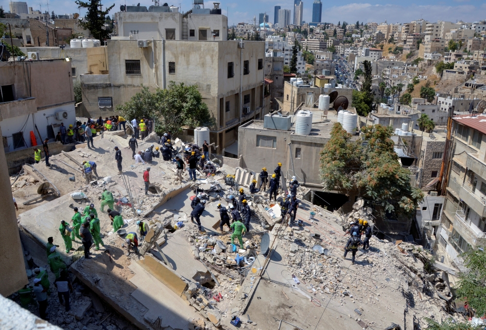 Rescuers search for survivors under the rubble of a collapsed building in Amman, Jordan September 14, 2022. REUTERS/Muath Freij/File Photo