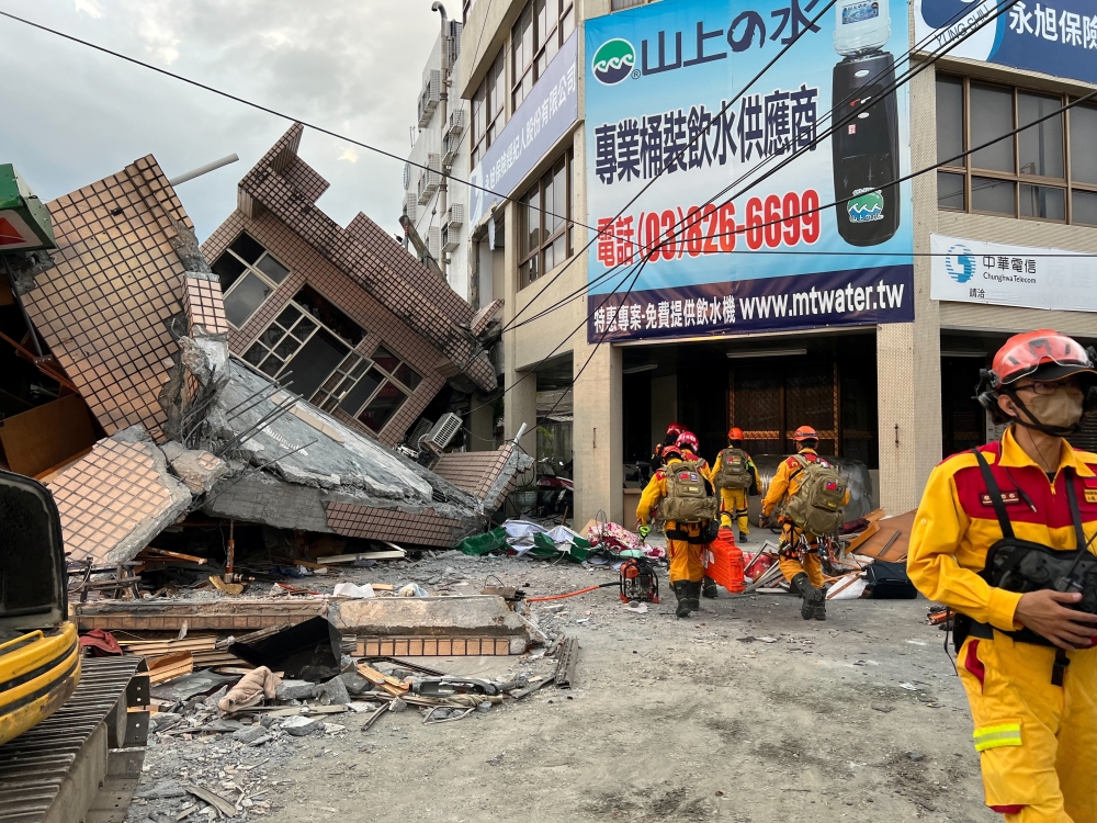 Firefighters work at the site where a building collapsed following a 6.8-magnitude earthquake, in Yuli, Hualien county, Taiwan September 18, 2022. Taiwan's 0918 Earthquake Central Emergency Operations Centre/Handout via Reuters