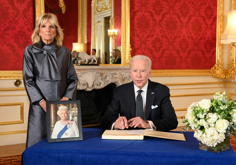 US President Joe Biden accompanied by the First Lady Jill Biden signs a book of condolence at Lancaster House in London, following the death of Queen Elizabeth II on September 18, 2022. Jonathan Hordle/Pool via REUTERS