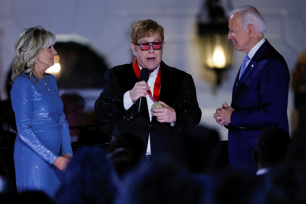 British rocker Elton John is awarded the National Humanities Medal by US President Joe Biden at the White House in Washington, US, September 23, 2022. Reuters/Evelyn Hockstein
