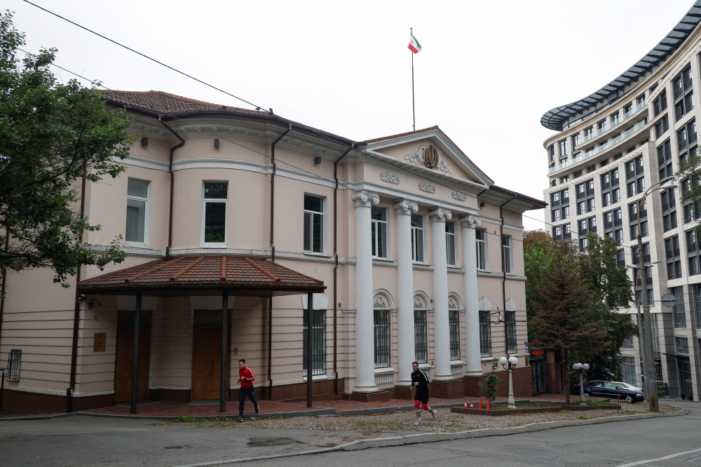Men ran past a building of the Iranian embassy, amid Russia's attack on Ukraine, in Kiev, Ukraine, on September 24, 2022. REUTERS/Valentyn Ogirenko