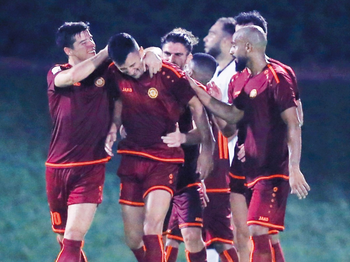 Umm Salal players celebrate.