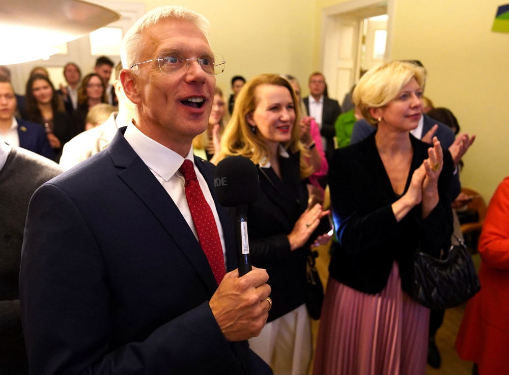 Latvian Prime Minister Arturs Krisjanis Karins reacts at 