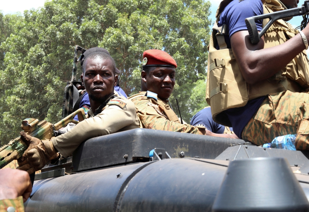 Burkina Faso's new military leader Ibrahim Traore is escorted by soldiers while he stands in an armoured vehicle in Ouagadougou, Burkina Faso, on October 2, 2022. (REUTERS/Vincent Bado)