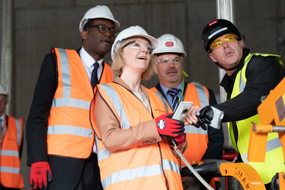 British Prime Minister Liz Truss and Chancellor of the Exchequer Kwasi Kwarteng react during a visit to a construction site for a medical innovation campus, on day three of the Conservative Party annual conference at the International Convention Centre in Birmingham, Britain, on October 4, 2022. Stefan Rousseau/Pool via REUTERS