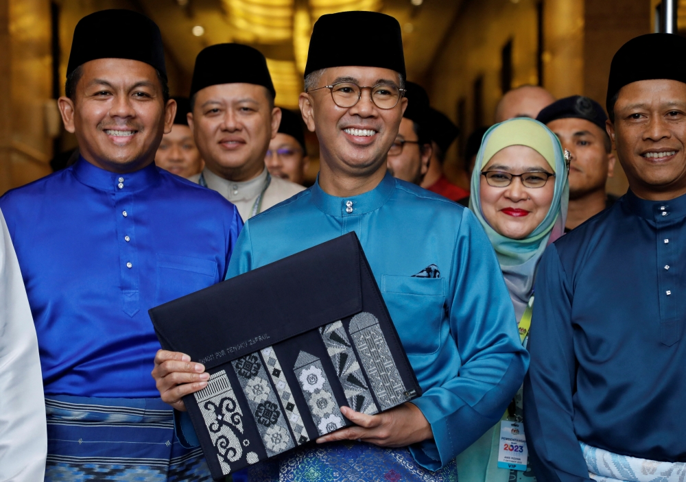 Malaysia's Finance Minister Tengku Zafrul holds a bag containing the 2023 budget at Finance Ministry building as he departs to the Parliament, in Putrajaya, Malaysia October 7, 2022. REUTERS/Hasnoor Hussain