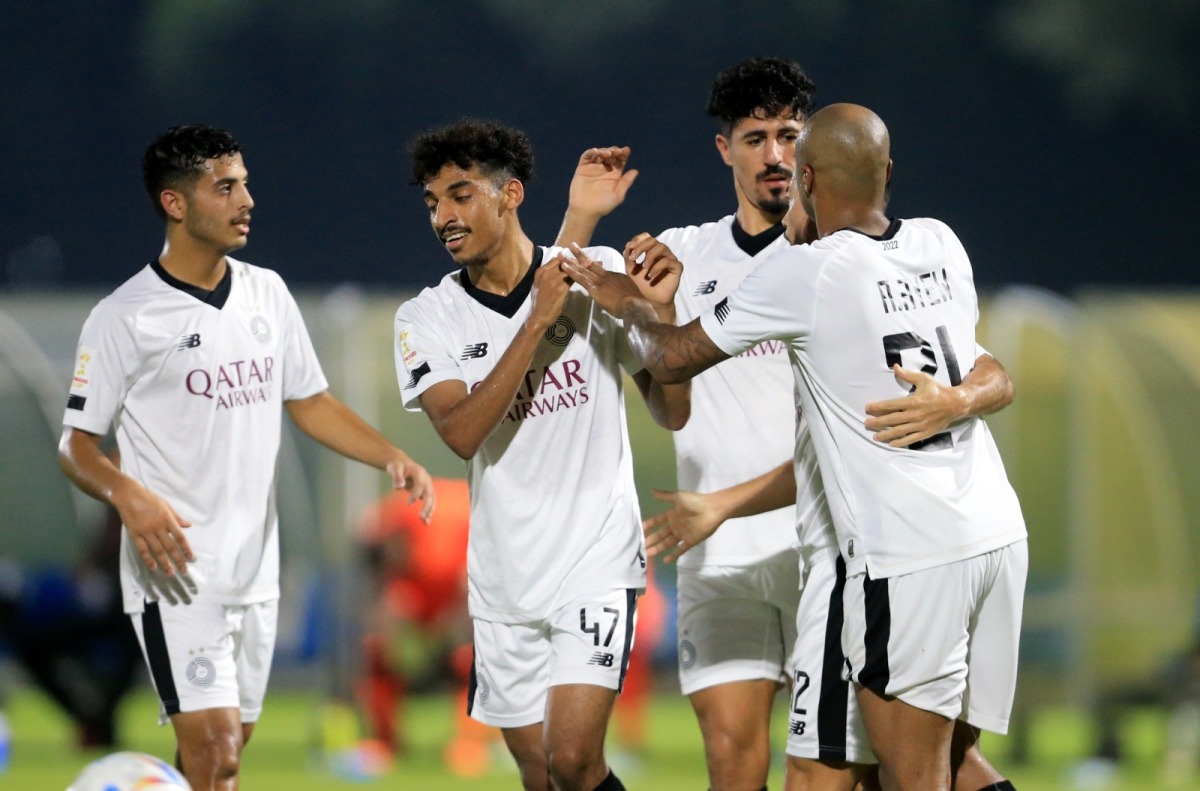 Al Sadd's Baghdad Bounedjah celebrates with team-mates.