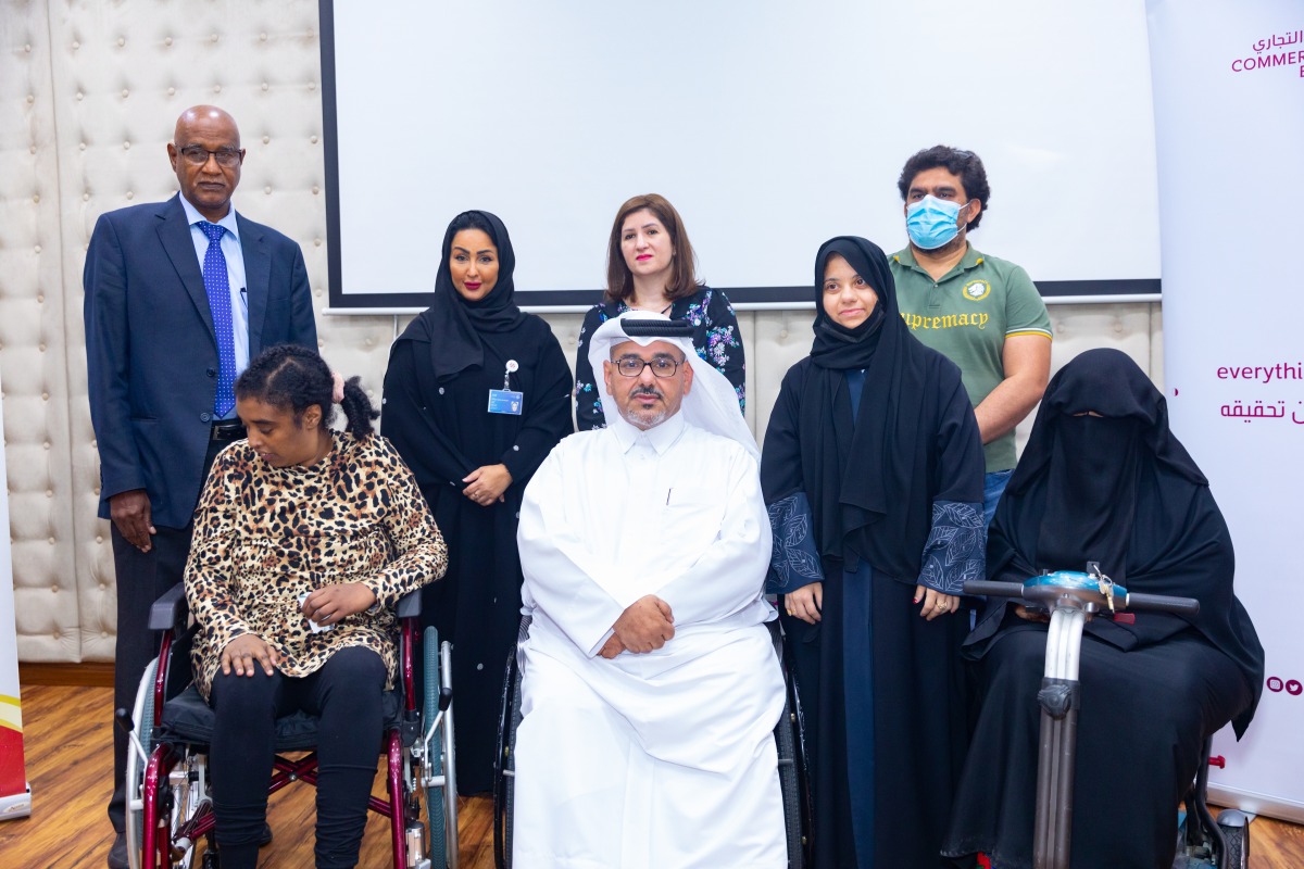 Officials and members from Commercial Bank and Qatar Society for Rehabilitation of Special Needs in Doha recently. 