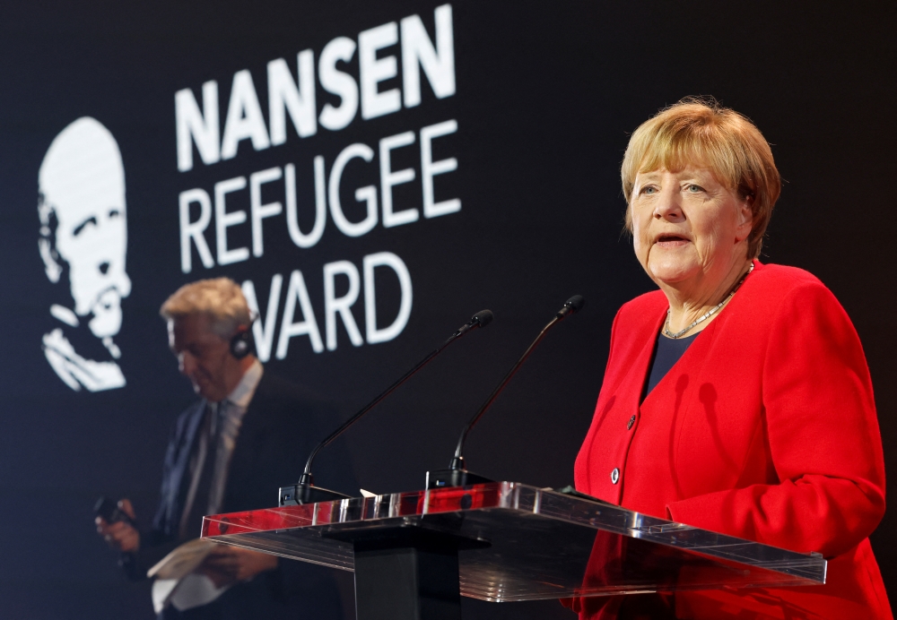 Angela Merkel speaks as she receives the UNHCR Nansen Refugee Award for protecting refugees at height of Syria crisis, during a ceremony in Geneva, Switzerland, October 10, 2022. (REUTERS/Stefan Wermuth)
