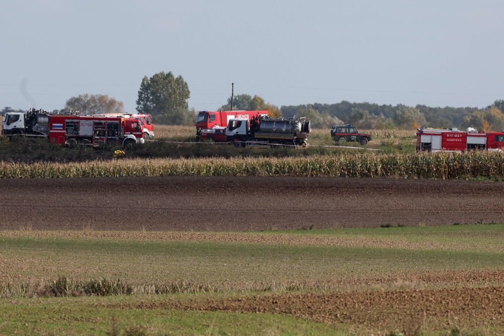 Firefighters work in the field near the Druzhba pipeline where an oil leak was detected, near the village of Zurawice, Poland, October 12, 2022. Reuters/Kacper Pempel