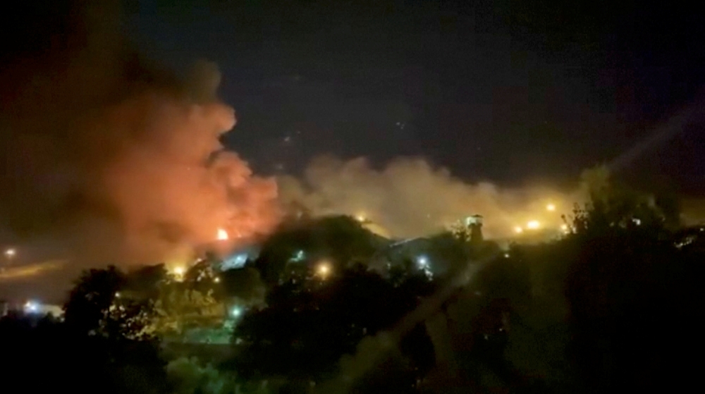 A view of smoke rising from Evin Prison in Tehran, Iran, October 15, 2022 in this still image take from a video obtained by Reuters. 
