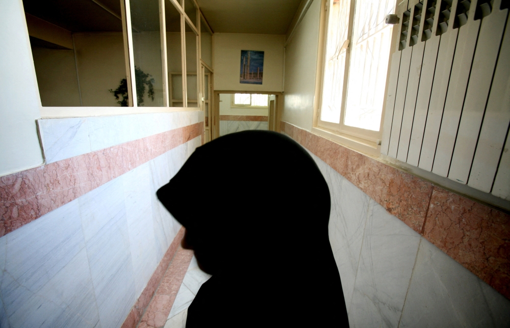 File photo of a female prison guard stands along a corridor in Tehran's Evin prison June 13, 2006. Reuters/Photo