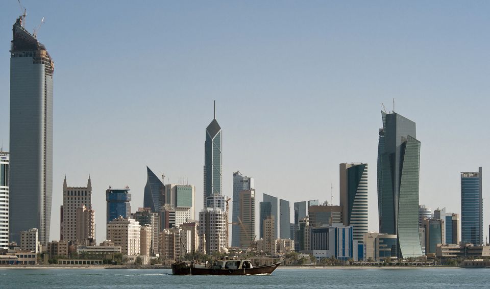 A fishing boat passes in front of the Kuwait City skyline on September 11, 2010.  File Photo / Reuters
