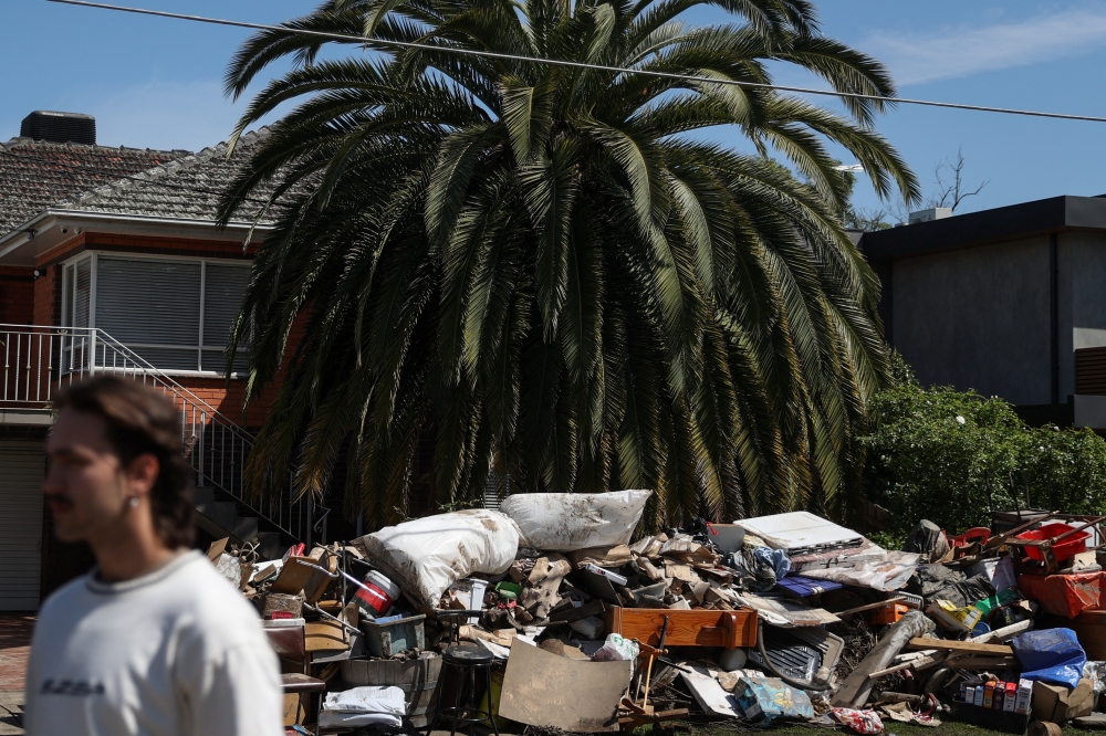 Piles of debris line a residential street following severe flooding and damage to homes in the Maribyrnong suburb of Melbourne, Australia, October 17, 2022. REUTERS/Loren Elliott
