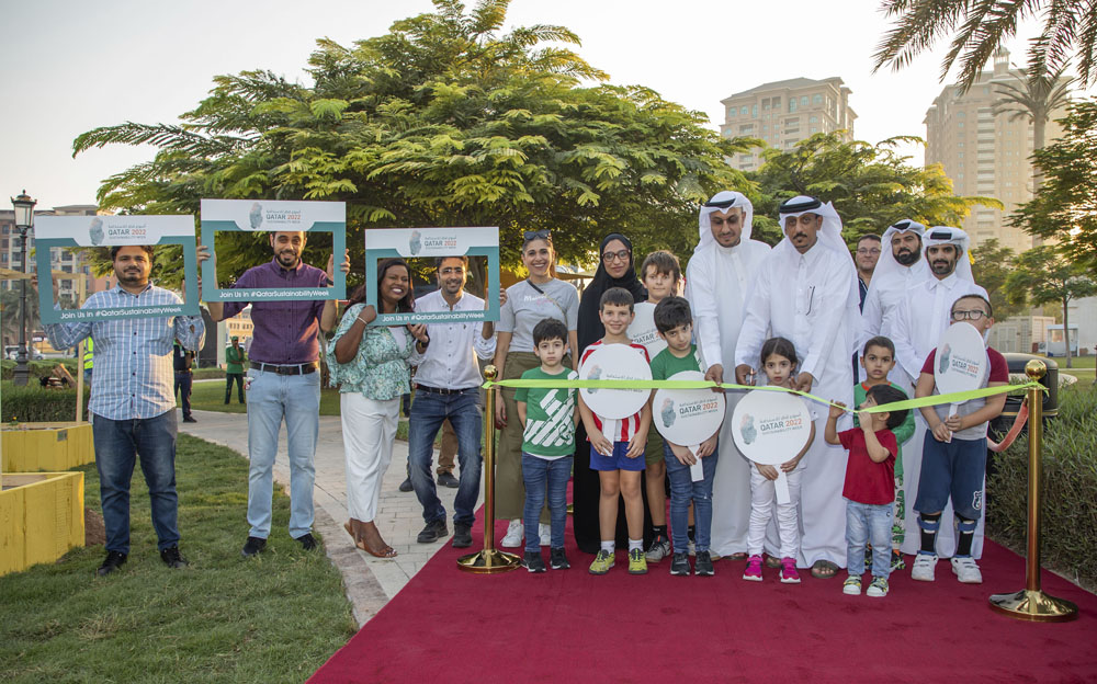 Officials with children and residents at the inauguration of a community garden at The Pearl Island. 