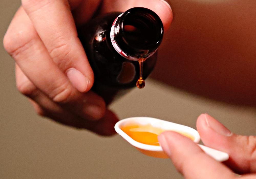 A cough medication is poured in this picture illustration taken October 19, 2022. REUTERS/Ajeng Dinar Ulfiana/Illustration
